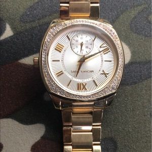 Women’s Micheal Kors gold watch.